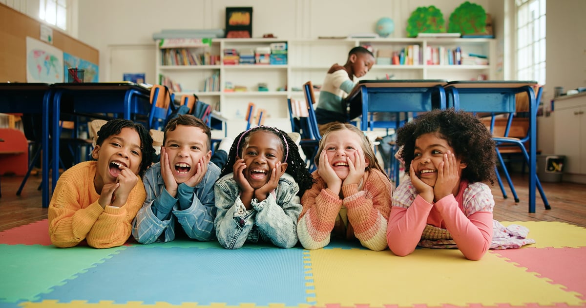 Portrait, group and children in classroom, happy and bonding in elementary, growth and development